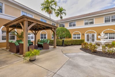 Outdoor seating area with palm trees and fountain