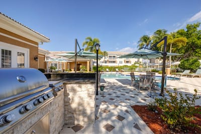 Outdoor pool area with grill and seating