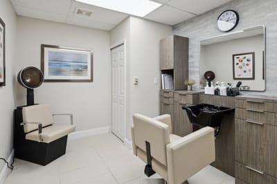 Modern hair salon area with styling chairs and equipment
