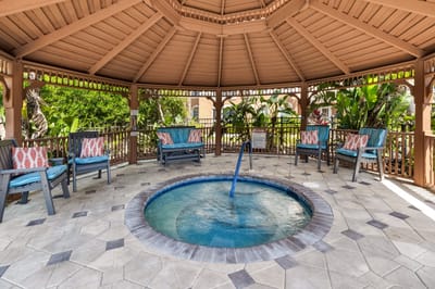 Cozy gazebo with a hot tub and seating