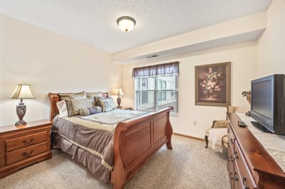 Cozy bedroom with wooden furniture and decor