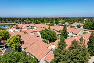 Aerial view of a senior living community with homes and green spaces