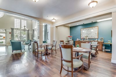 Bright and inviting common area with tables and seating