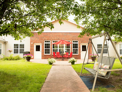 A welcoming outdoor patio with seating and greenery