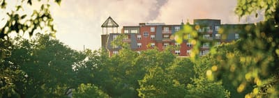 Exterior view of a retirement community surrounded by trees