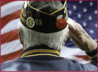 Avery Heights Assisted Living and Memory Care, independent living in Hartford, CT — Veteran saluting in front of an American flag