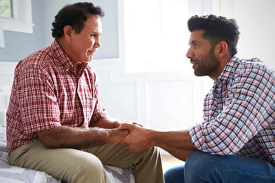 A senior man and a caregiver engaging in conversation