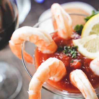 Meadowcrest – Middletown, Assisted Living in Middletown, DE — Shrimp cocktail in a glass with lemon and herbs