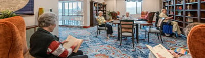 Residents reading in a cozy common area