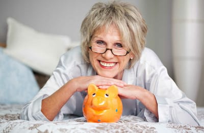 Meadowcrest – Middletown, Assisted Living in Middletown, DE — Smiling senior woman with a piggy bank
