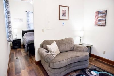 Cozy interior of a resident's room with a couch and lamp