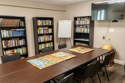 Interior view of a meeting room with bookshelves and a table