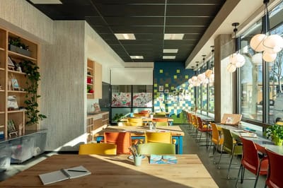Bright and modern dining area with colorful chairs
