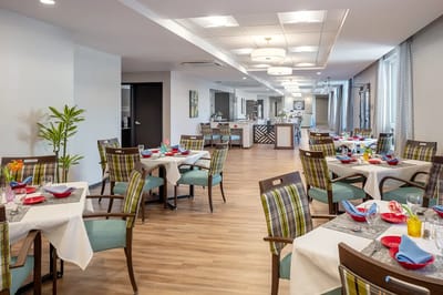 Bright dining room with tables set for meals