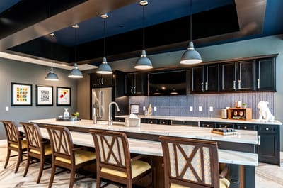 Modern kitchen area with seating and pendant lighting