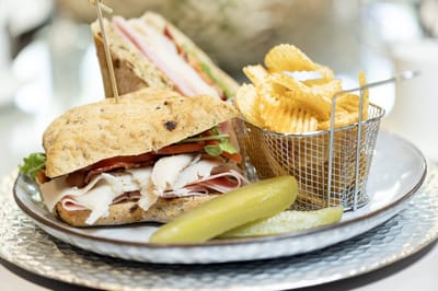 A sandwich platter with chips and a pickle