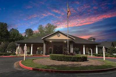 Exterior view of Carriage Crossing Senior Living at sunset