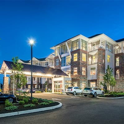 Exterior view of a senior living facility at night