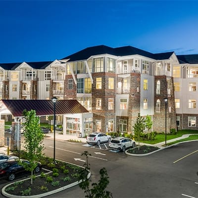 Exterior view of a modern assisted living facility at dusk