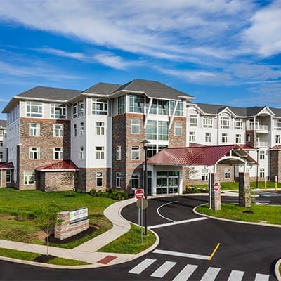 Exterior view of a modern assisted living facility with landscaping