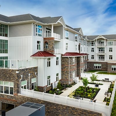 Exterior view of a modern assisted living facility with gardens