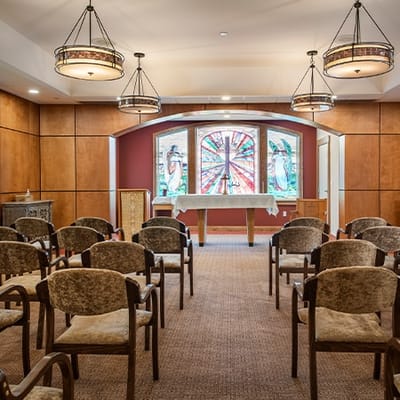 Interior chapel with stained glass windows and chairs