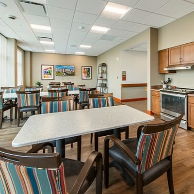 Bright common area with dining tables and kitchen