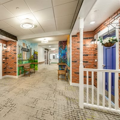 Interior hallway with vibrant murals and seating