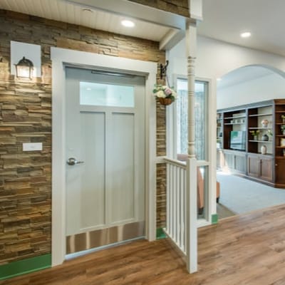Interior view of a facility corridor with stone wall