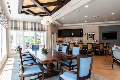 Bright common area with dining table and chairs