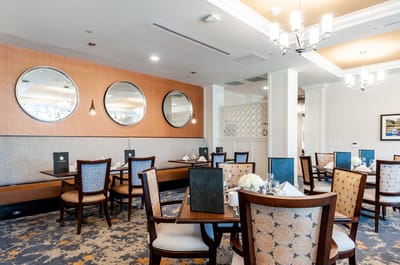 Elegant dining room with circular mirrors and set tables