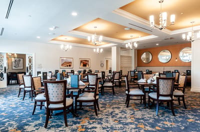 Bright and elegant dining room with wooden tables and chairs