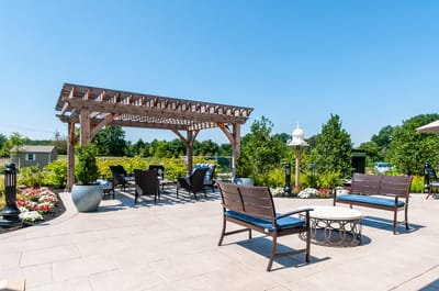 Outdoor seating area with pergola and flowers