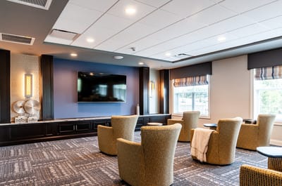 Interior common area with seating and a television