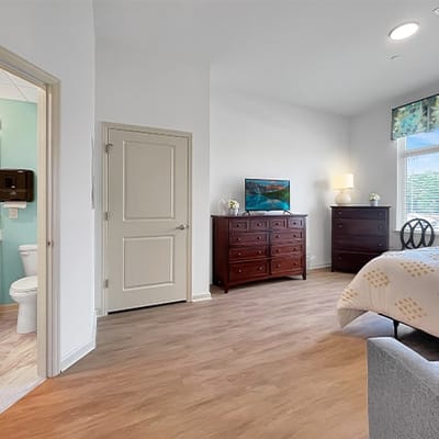 A well-decorated private resident room with furniture
