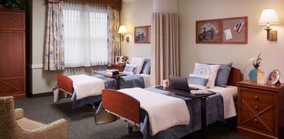 A shared resident room with two beds and decor
