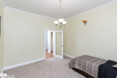 Interior view of a simple private room with a bed