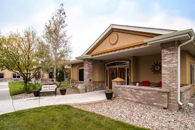 Exterior view of a senior living facility with landscaped entrance