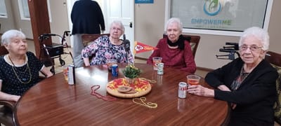 Four residents enjoying a social gathering around a table