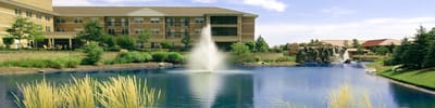 Exterior view of assisted living facility with pond