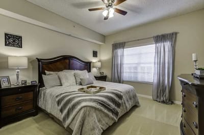 Cozy bedroom with a large window and warm lighting