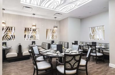 Modern dining area with tables and chairs set for meals