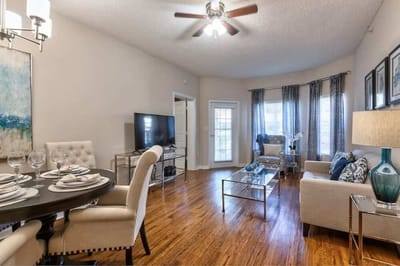 Bright interior common area with seating and dining setup