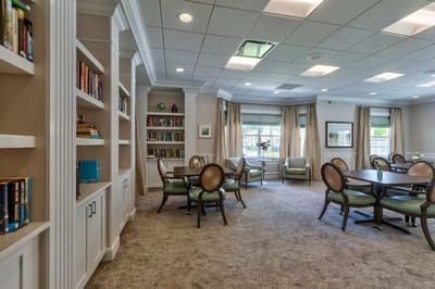 A cozy common area with seating and bookshelves
