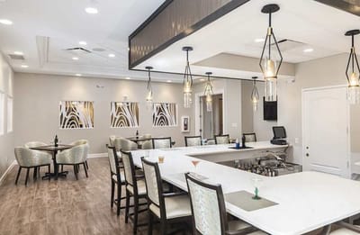 Bright and inviting community lounge with seating and bar