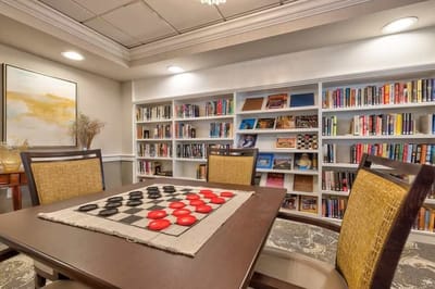 Common area with a checkers game and bookshelves