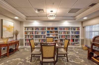 Cozy common area with bookshelves and a dining table