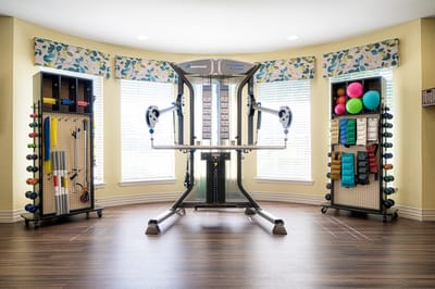 Well-equipped fitness area with exercise equipment and weights
