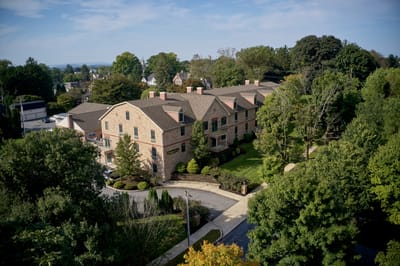 Aerial view of a senior living facility surrounded by trees