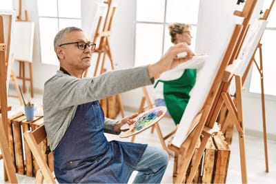 Residents participating in an art activity indoors